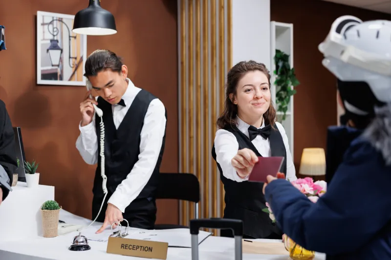 tourist-giving-passport-receptionist
