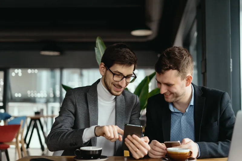 two-businessmen-having-conversation-using-smartphone
